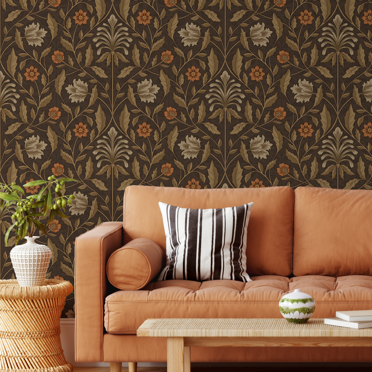 Hawthorn House brown floral wallpaper with rust orange flowers styled behind a warm orange sofa in a vintage living room.