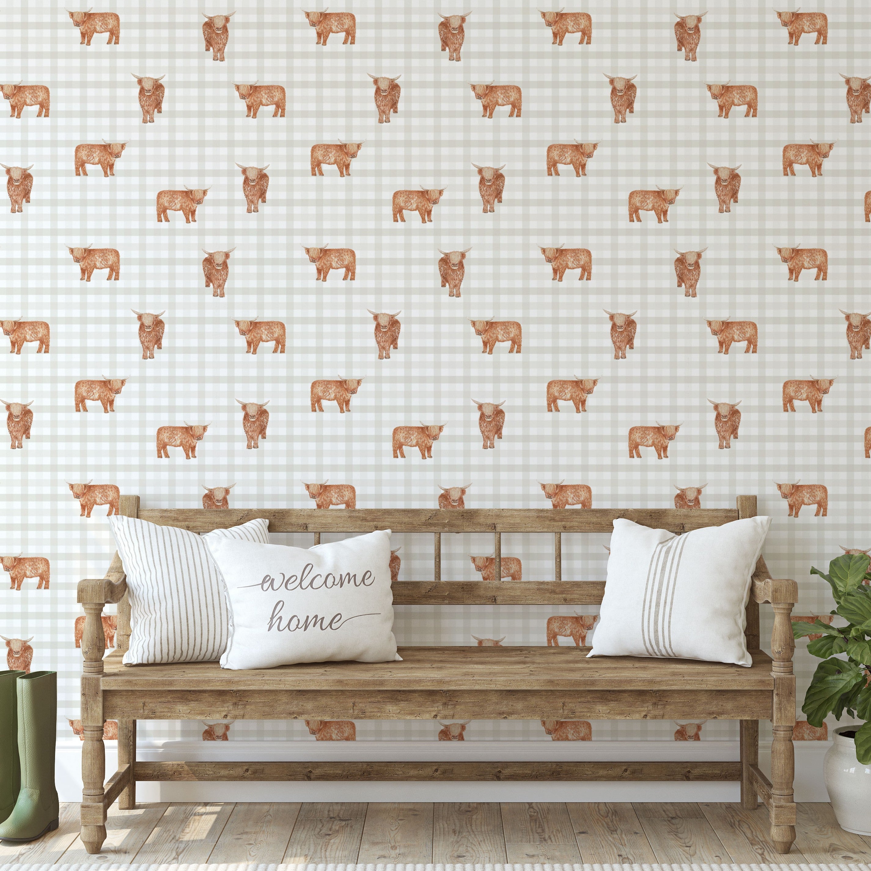 Wooden bench with 'welcome home' pillow against a wall with gingham highland cow pattern