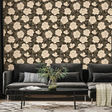 Living room with a black sofa against a wall with floral wallpaper