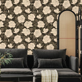 Vintage rose wallpaper installed in a moody living room with dark sofa and neutral decor