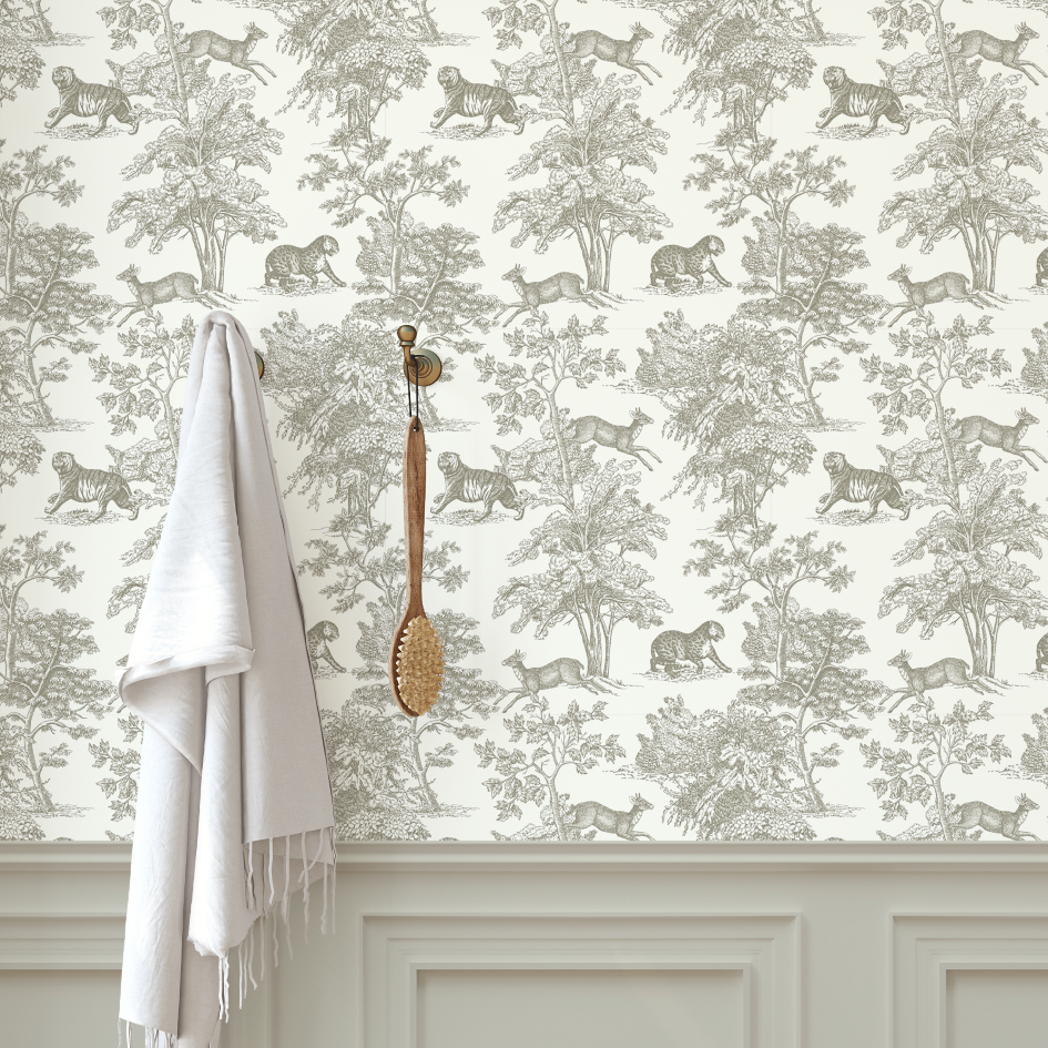 Wallpaper with jungle animal pattern, white towel, and brush against a neutral wall.