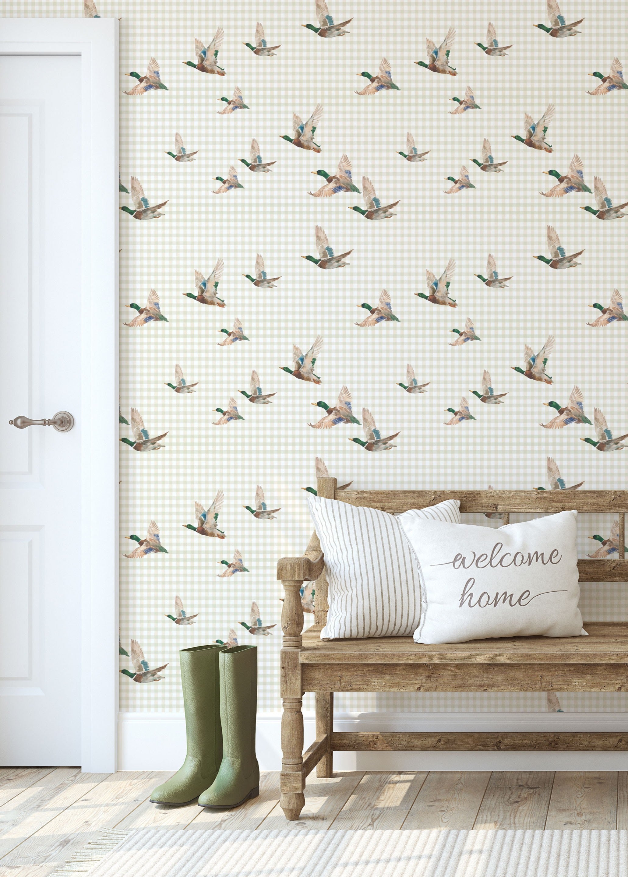 Entryway with mallard duck wallpaper, wooden bench, welcome pillows, and green boots