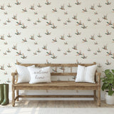 Wide room view with mallard duck wallpaper and rustic bench between two doors