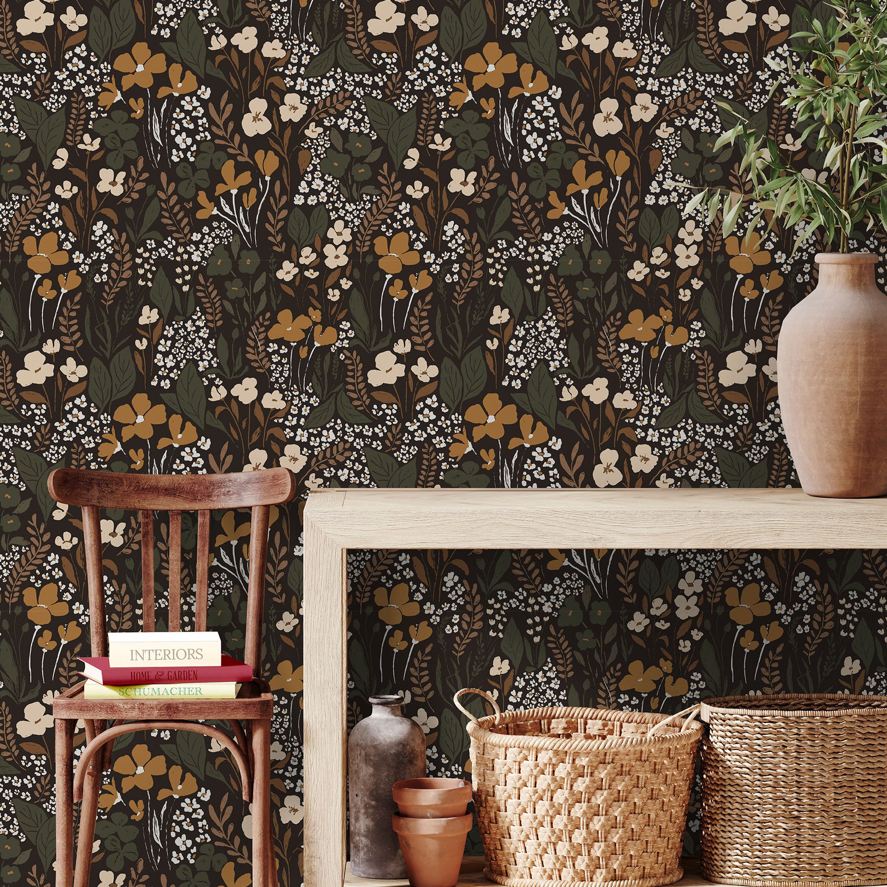 Dark wildflower wallpaper styled in an entryway with natural wood furniture and woven accents
