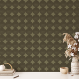 Olive green mod dot wallpaper styled with neutral desk decor and cotton stems