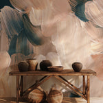 Abstract brushstroke wall mural in earthy beige, tan, and dark green tones styled with pottery and wooden console table