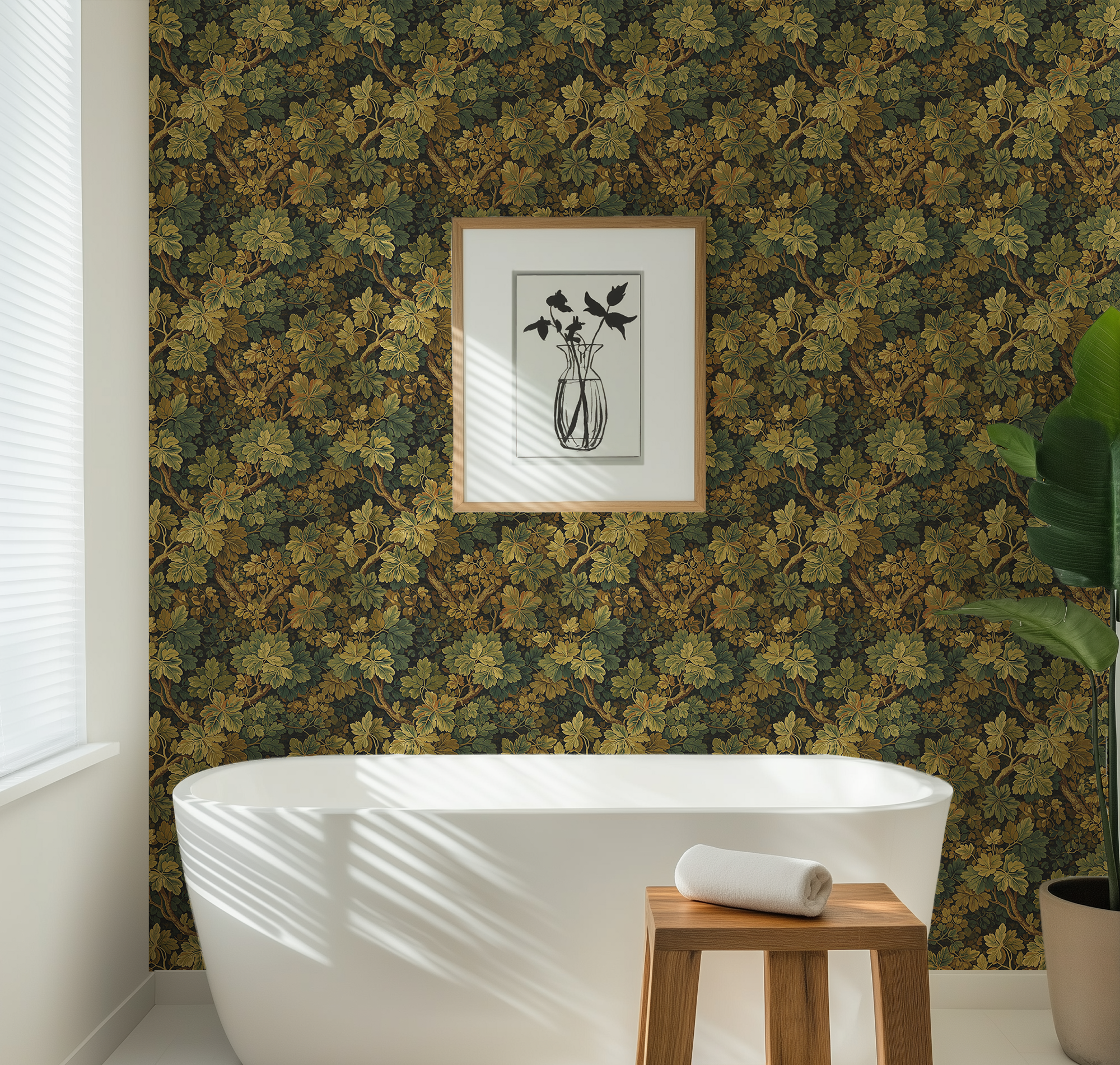 Moss Leaf wallpaper styled in a bathroom with a white freestanding tub, wood stool, framed art, and greenery.