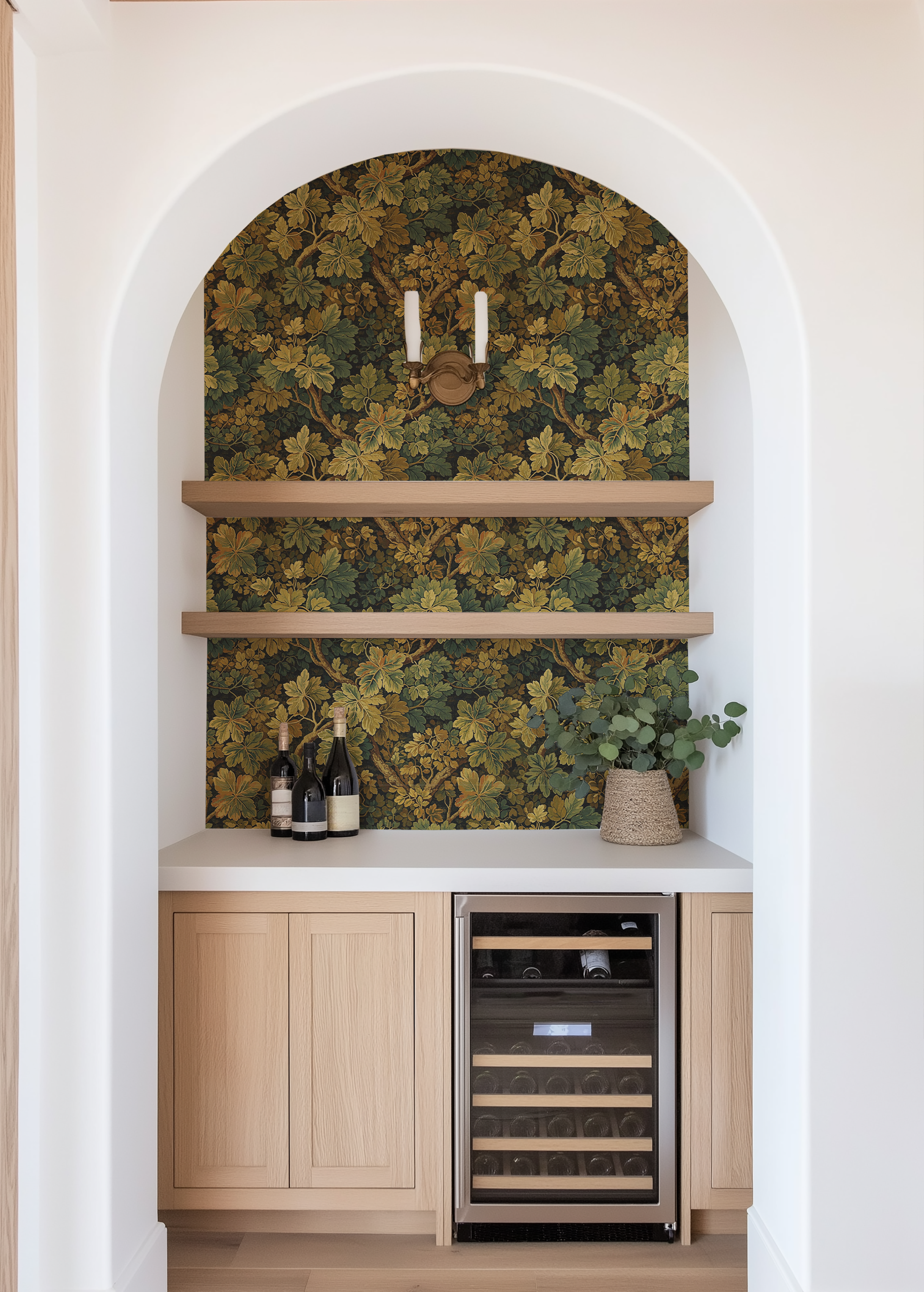 Moss leaf wallpaper used inside an arched bar nook with wood shelving, wine storage, and soft neutral cabinetry.