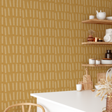 Mustard yellow brushstroke wallpaper in a modern kitchen with open wood shelving and warm neutral decor