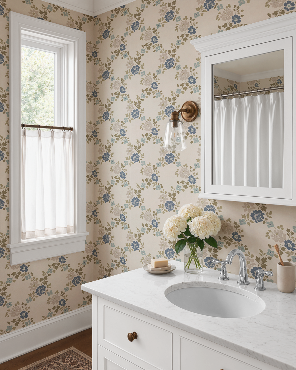 Traditional bathroom featuring blue green floral trellis wallpaper, white vanity, brass lighting and classic cottage design.