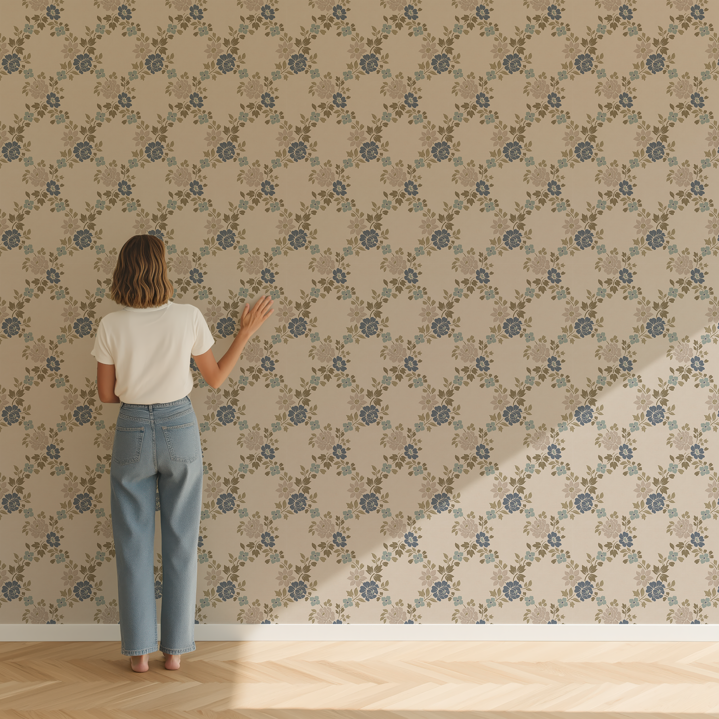 Scale reference of muted blue green floral trellis wallpaper installed on a full wall with person for size comparison.