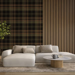 Dark olive and black tartan plaid wallpaper in a modern living room with wood slat accents and neutral furniture.