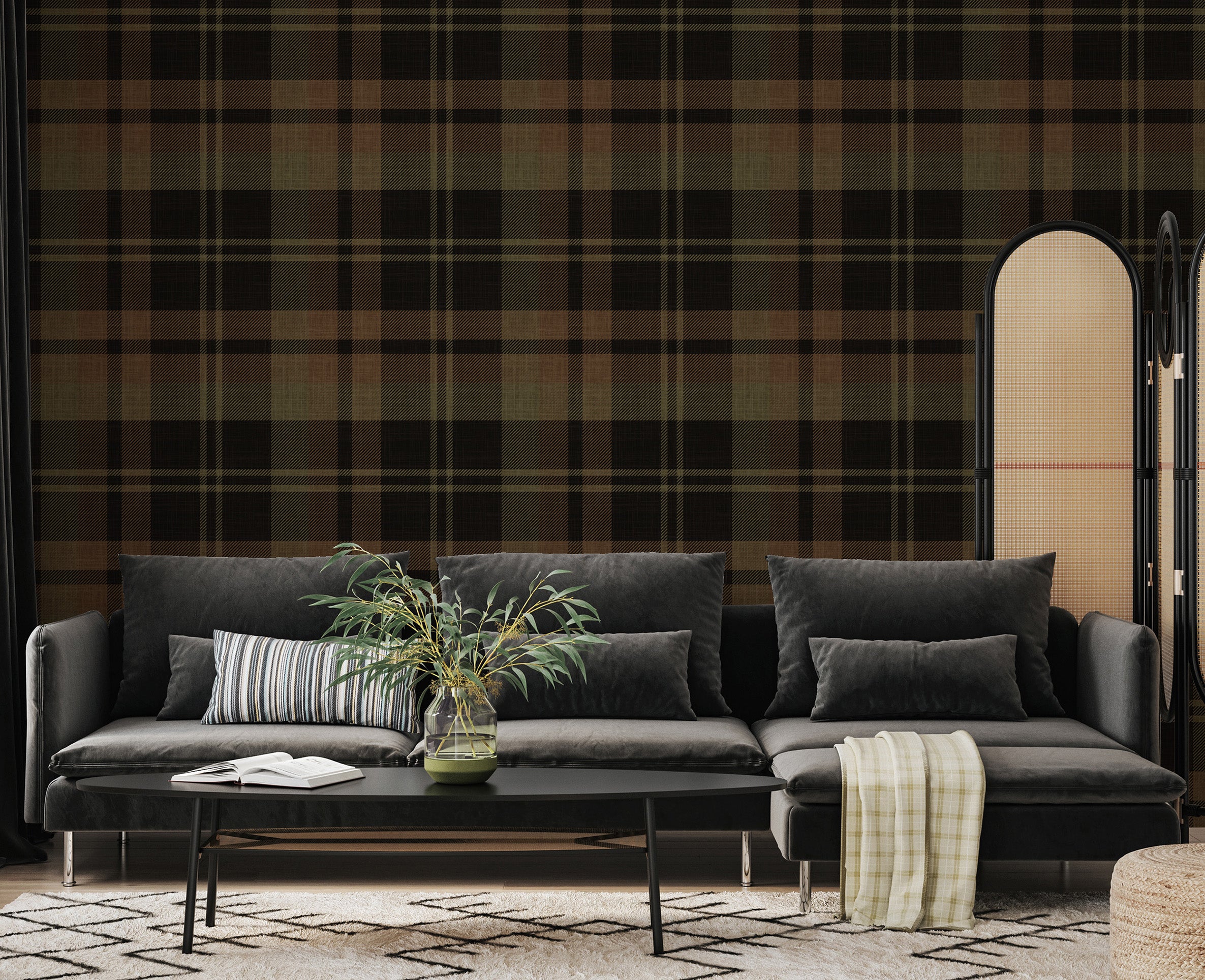 Olive and black tartan plaid wallpaper behind a charcoal sectional sofa and room divider in a modern interior.