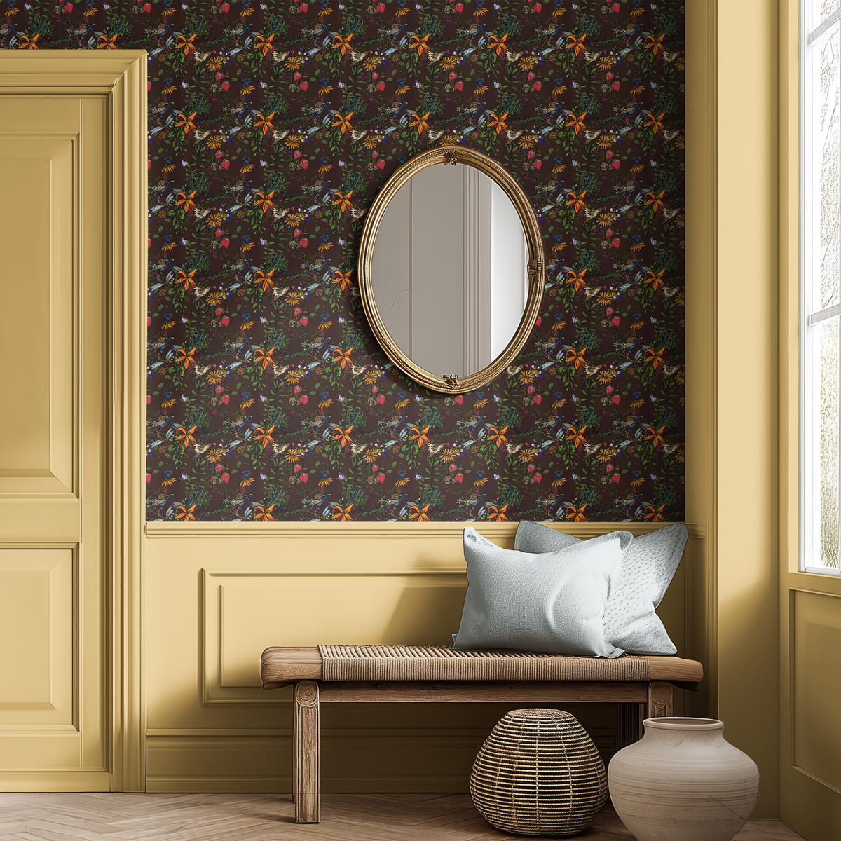 Moody peacock floral wallpaper with colorful botanical illustrations, warm yellow wall paneling, vintage gold mirror and wooden entryway bench.