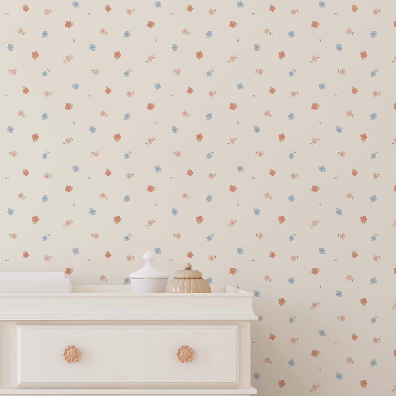 pastel floral nursery wallpaper behind white changing dresser in soft neutral baby room