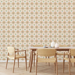 Dining area with wooden table and chairs against a floral diamond patterned wallpaper.