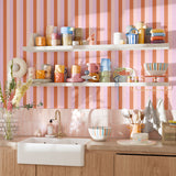 Colorful kitchen with Taffy stripe wallpaper behind open shelving and mugs