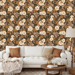 Full wall view of Rosehip Briar botanical wallpaper showing repeating floral pattern behind a modern sofa