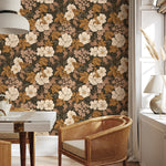 Rosehip Briar vintage floral wallpaper in a cozy seating area with woven chair and natural wood furniture