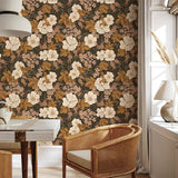 Rosehip Briar vintage floral wallpaper in a cozy seating area with woven chair and natural wood furniture