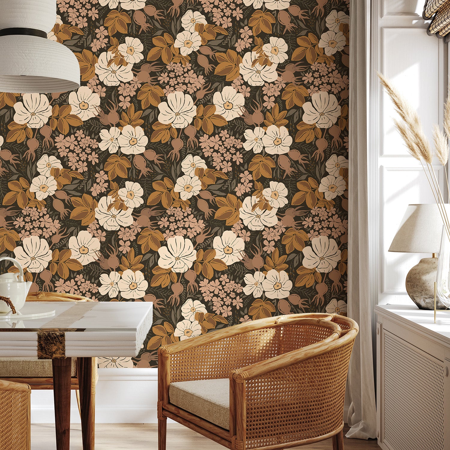 Rosehip Briar vintage floral wallpaper in a cozy seating area with woven chair and natural wood furniture