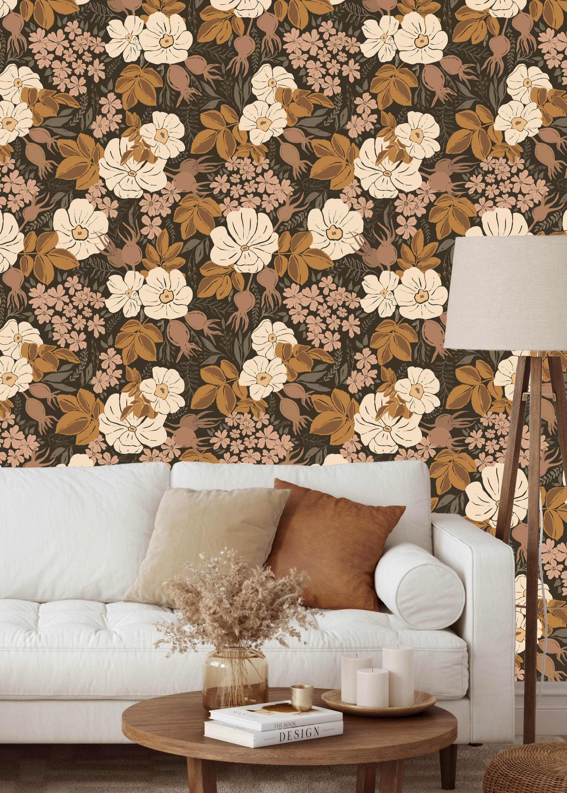 Rosehip Briar floral wallpaper styled in a living room with a white sofa, wood coffee table, and neutral decor