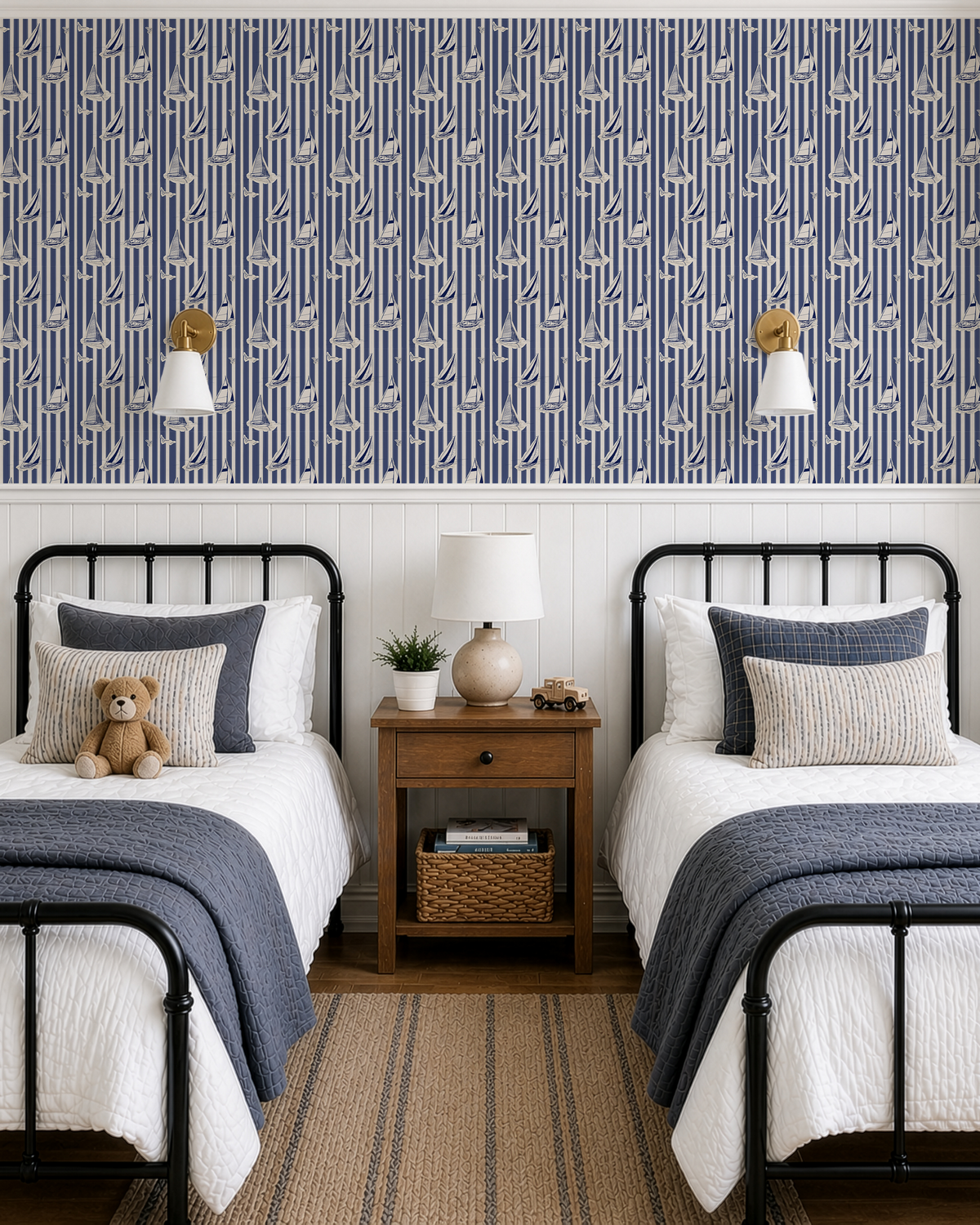 Blue nautical sailboat wallpaper in a shared kids bedroom with twin beds, striped design and vintage coastal style