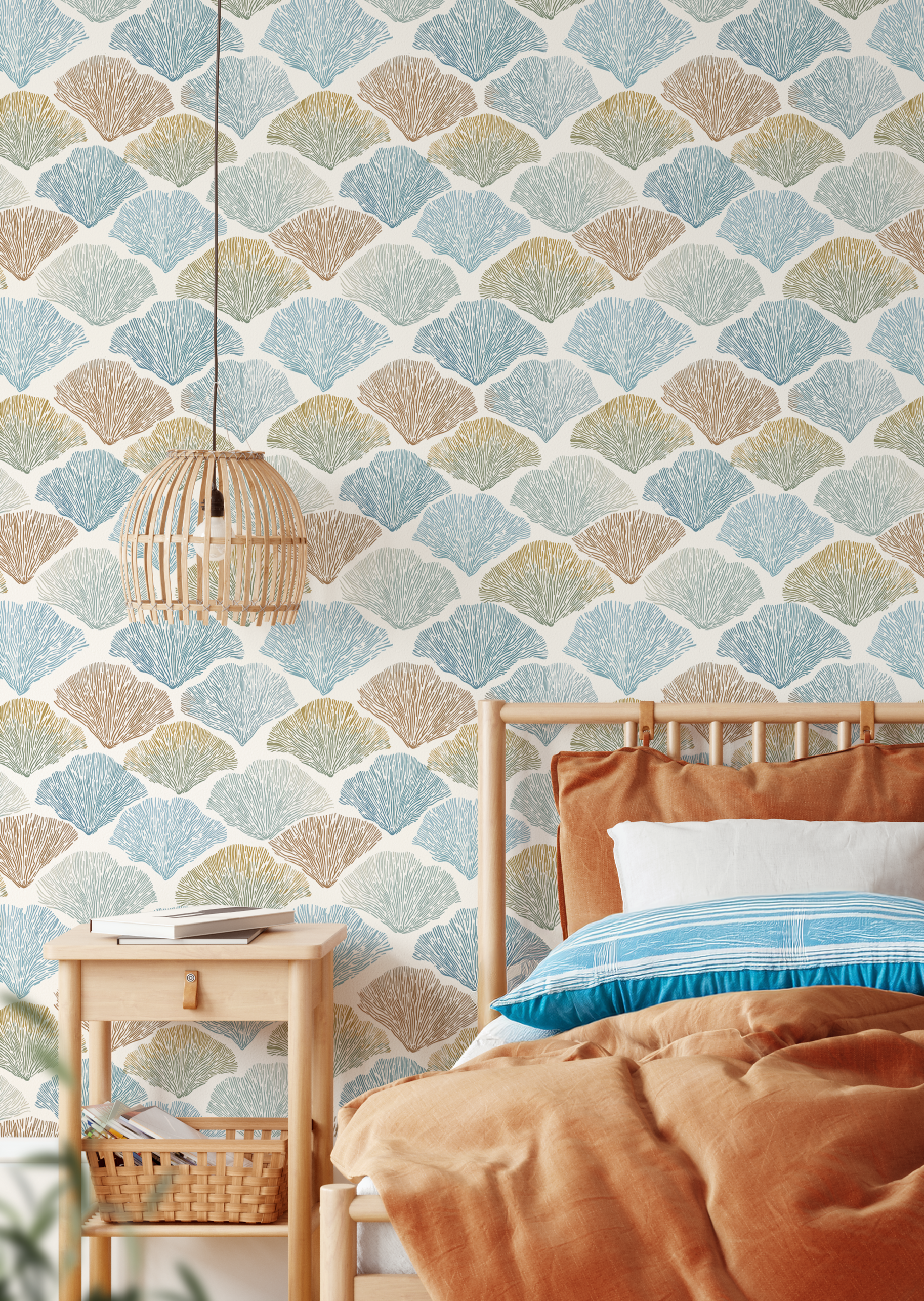 coastal bedroom with shell wallpaper, blue and tan seaside pattern with wood furniture and warm bedding