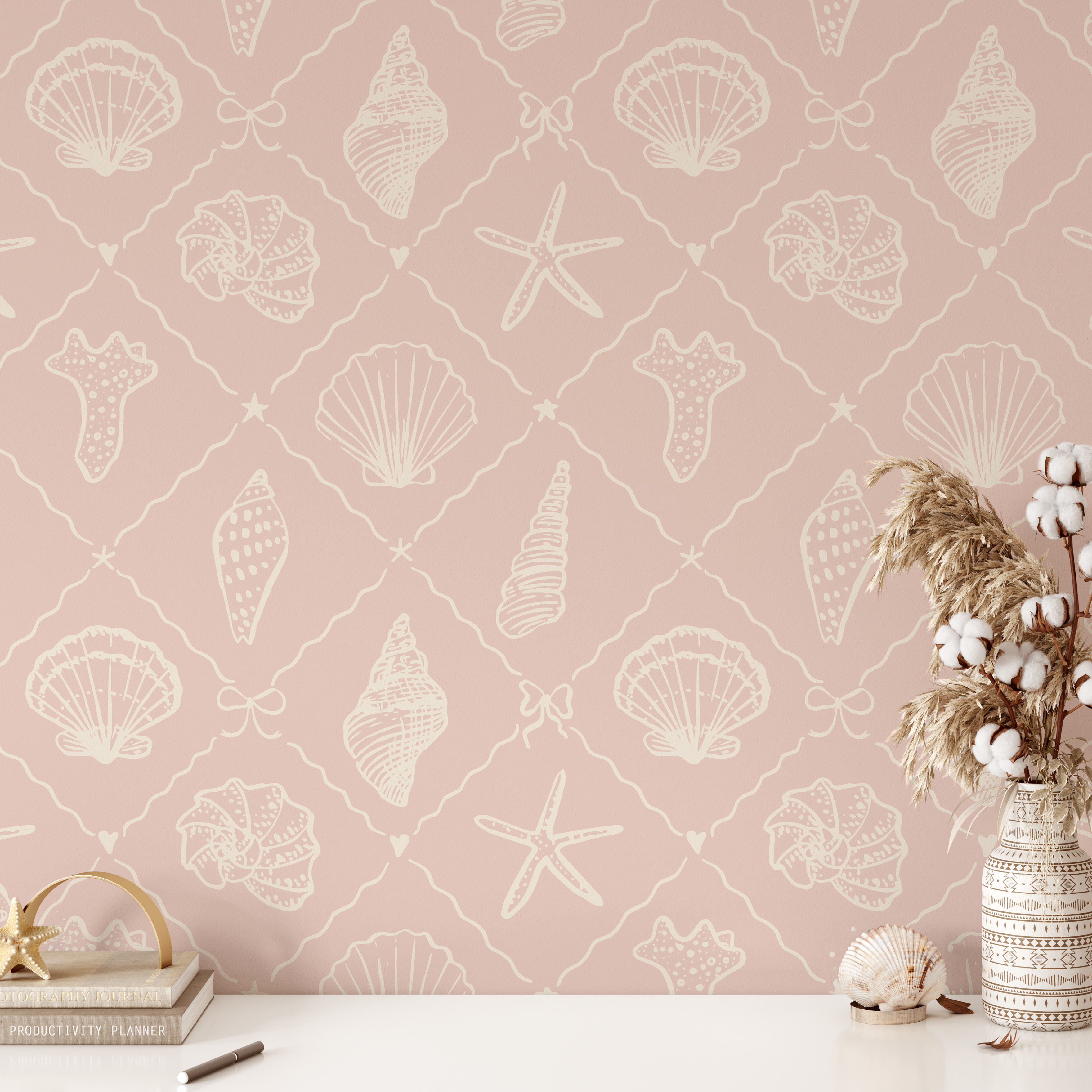 coastal pink wallpaper with seashell and starfish pattern styled with neutral decor and beach accessories