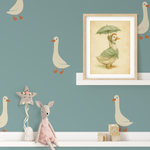 Goose wall stickers on teal wall with nursery shelf, framed goose artwork, and plush toys