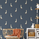 Goose wall decals on navy blue wall with rattan crib, wicker baskets, and nursery storage.
