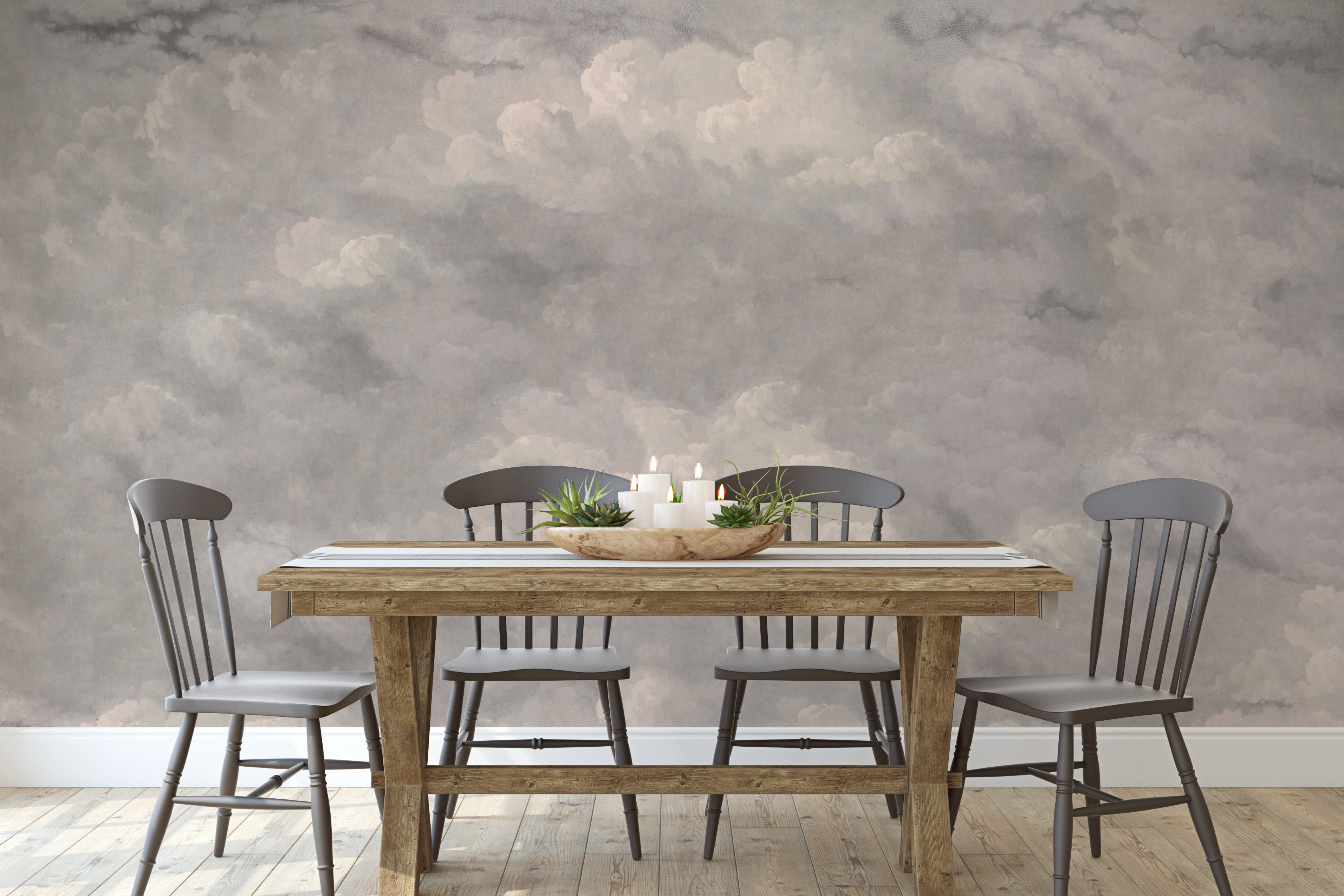 Soft grey sky mural featuring hand-painted clouds behind a farmhouse dining table and chairs
