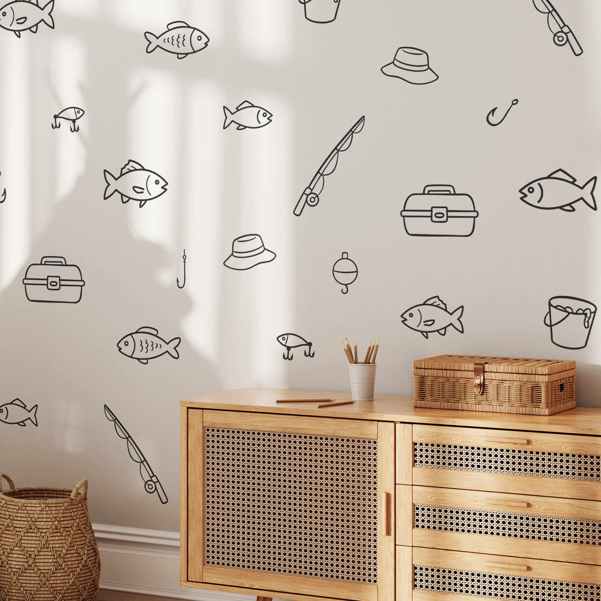 Fishing decals on white wall above wicker cabinet, minimalist fish and fishing gear wall decals for lake house or cabin wall art.