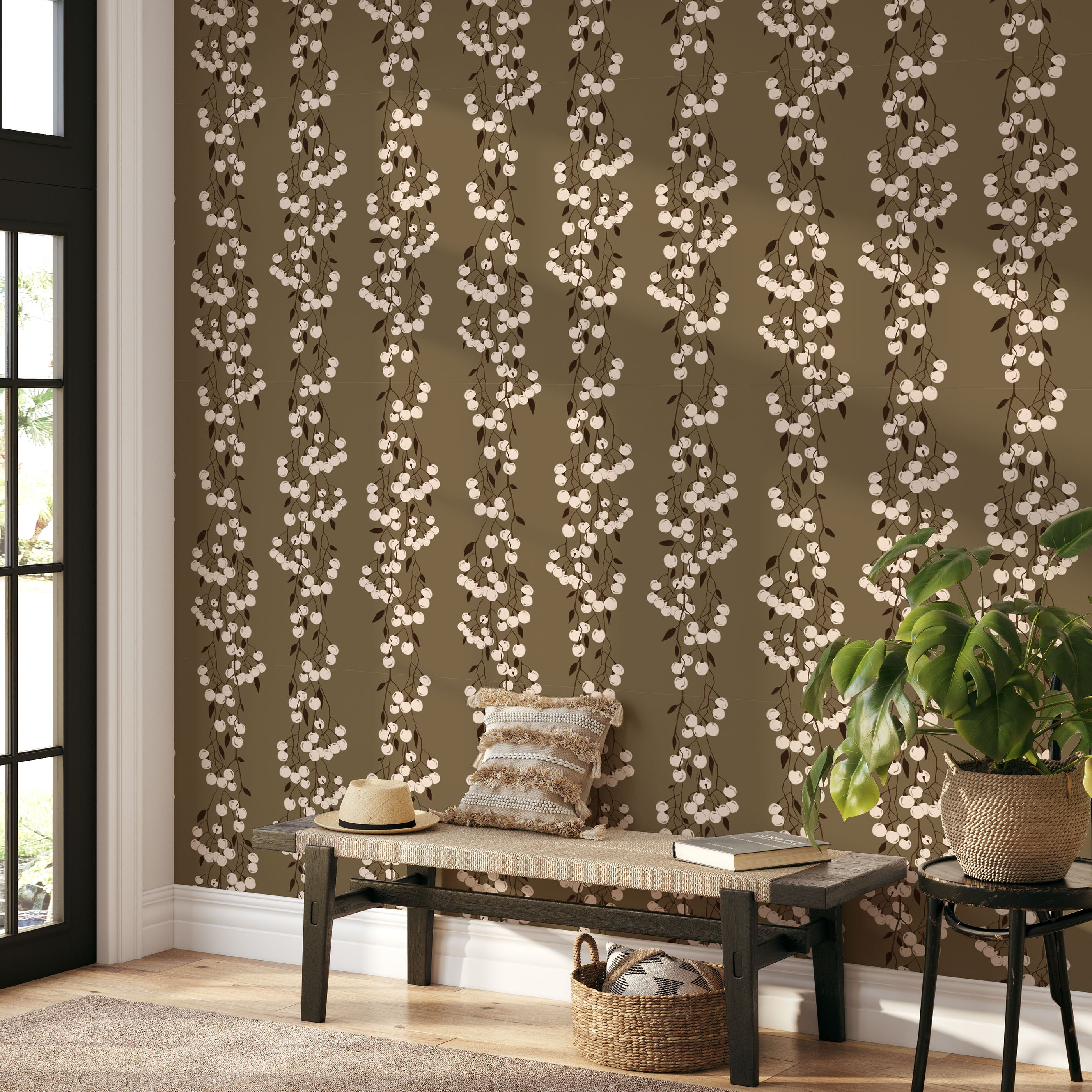 Snowberry Trail wallpaper installed behind a green sofa, highlighting the vertical botanical stripe design.