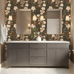 Stillwood floral wallpaper installed behind a bathroom vanity with brass sconces and neutral cabinetry