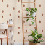Strawberry wallpaper styled in a room with a wooden ladder shelf, trailing plants, and a woven basket planter