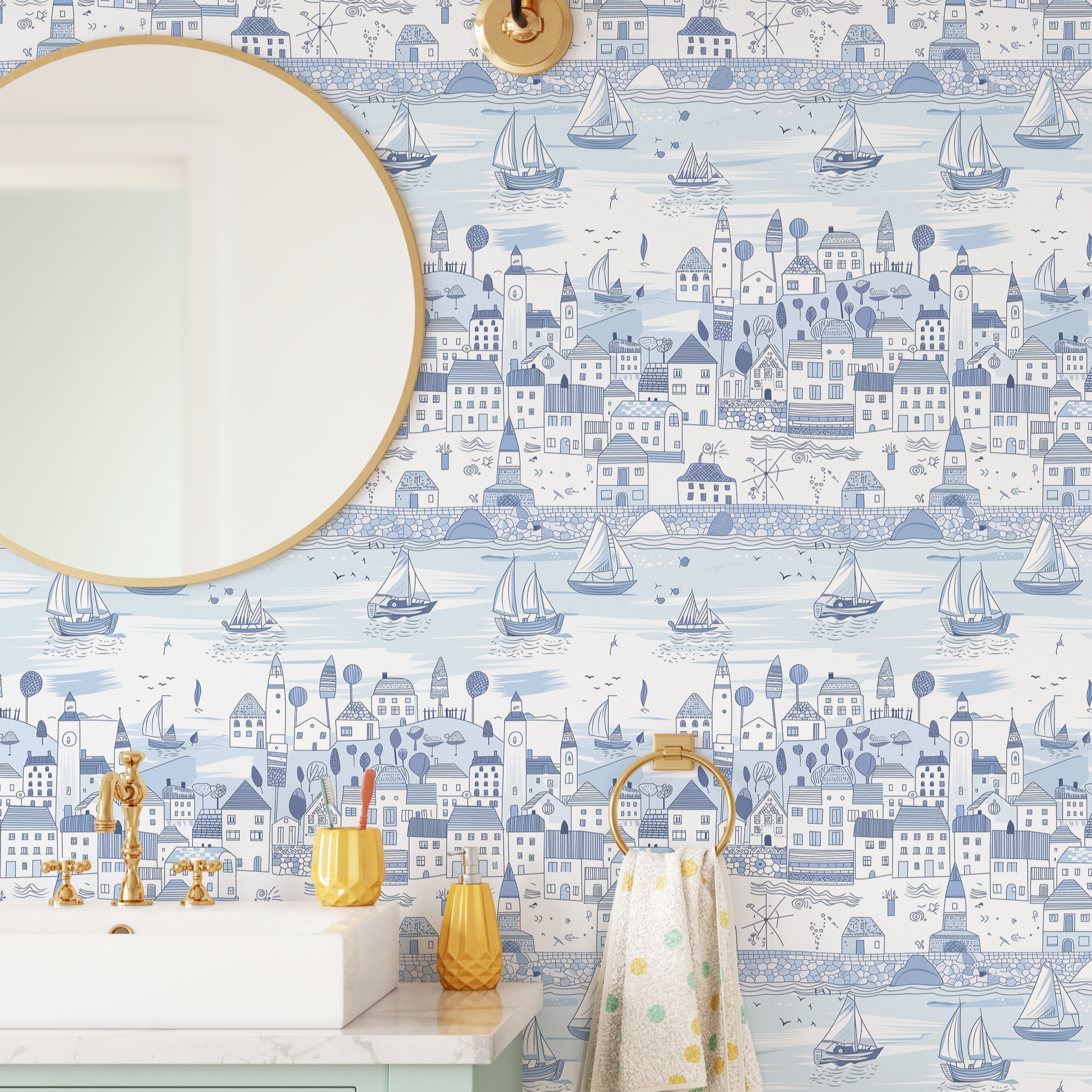Close-up of light blue nautical wallpaper with sailboats and illustrated coastal homes