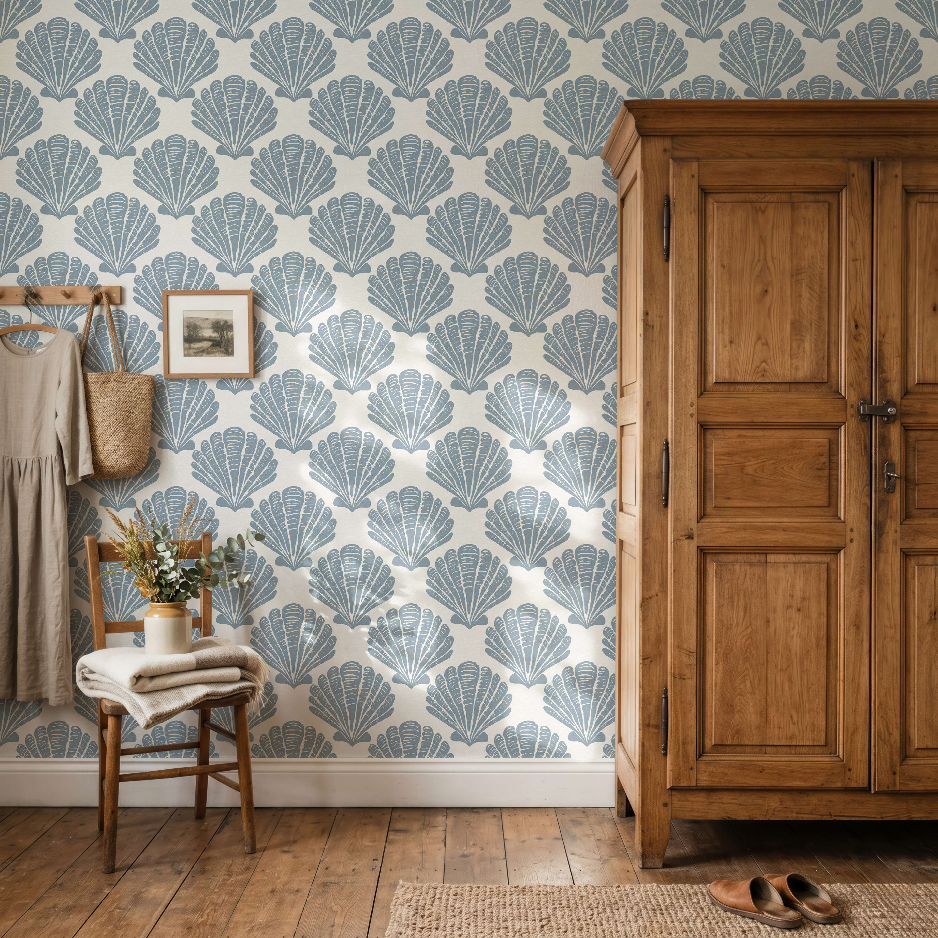 Tidepool Shell wallpaper in a rustic bedroom featuring blue coastal seashell wallpaper with warm wood furniture and cottage-inspired decor.