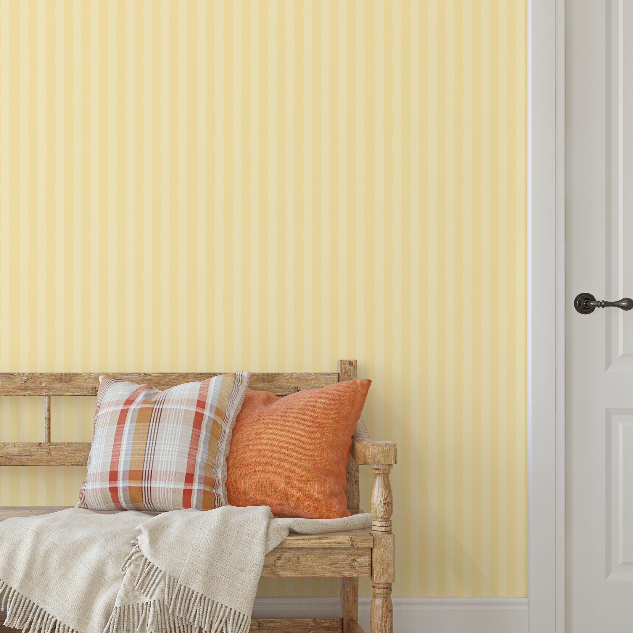 Yellow striped wallpaper in an entryway with rustic wooden bench and orange pillows.