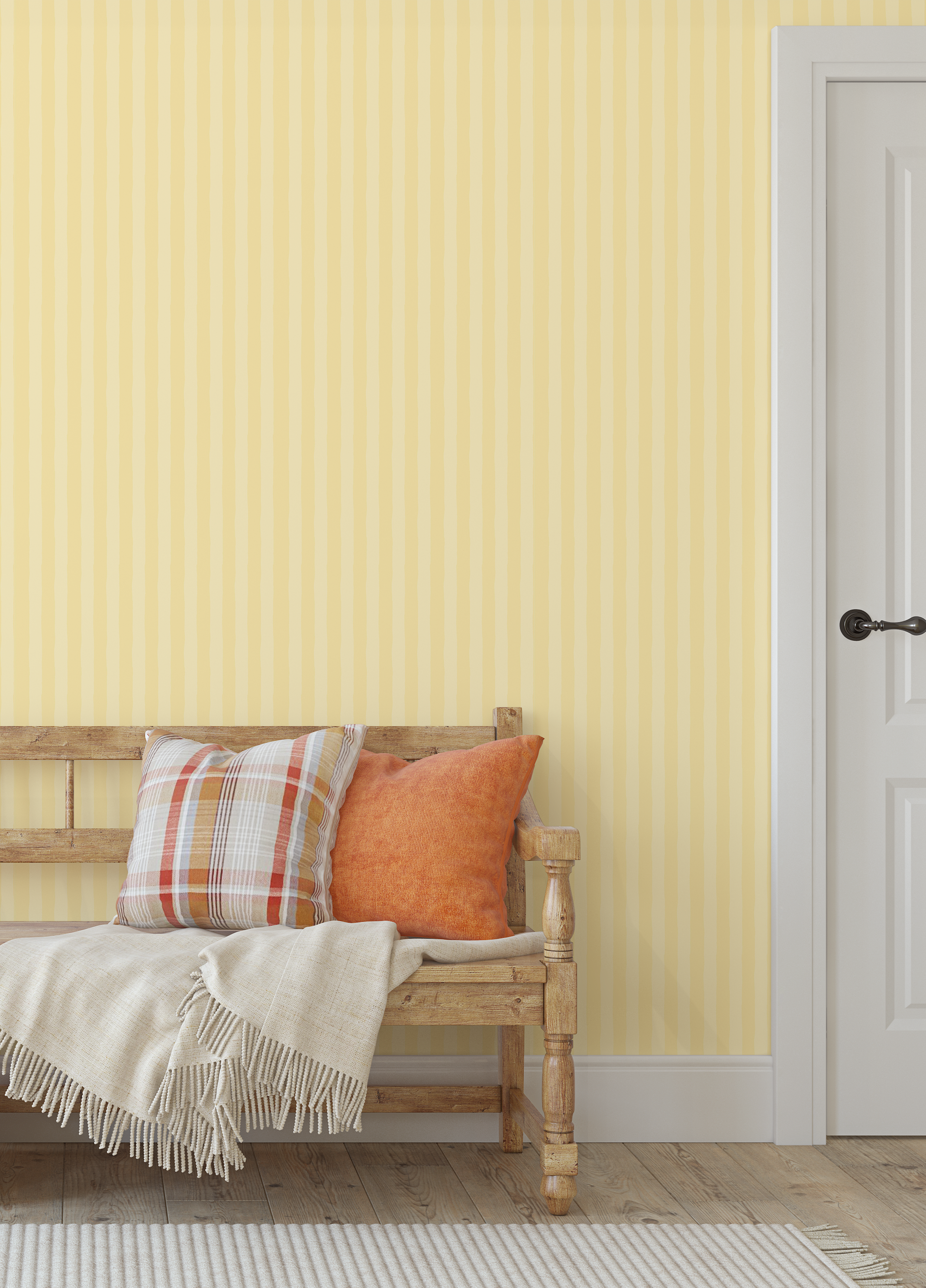 Yellow striped wallpaper in an entryway with rustic wooden bench and orange pillows.