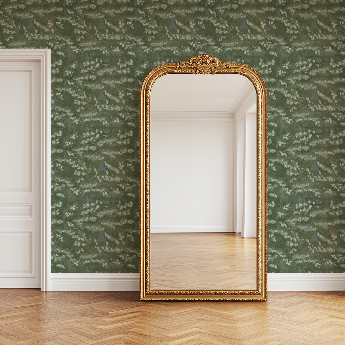 Venetian Greenwash botanical wallpaper with soft green evergreen foliage styled behind an ornate vintage gold floor mirror.