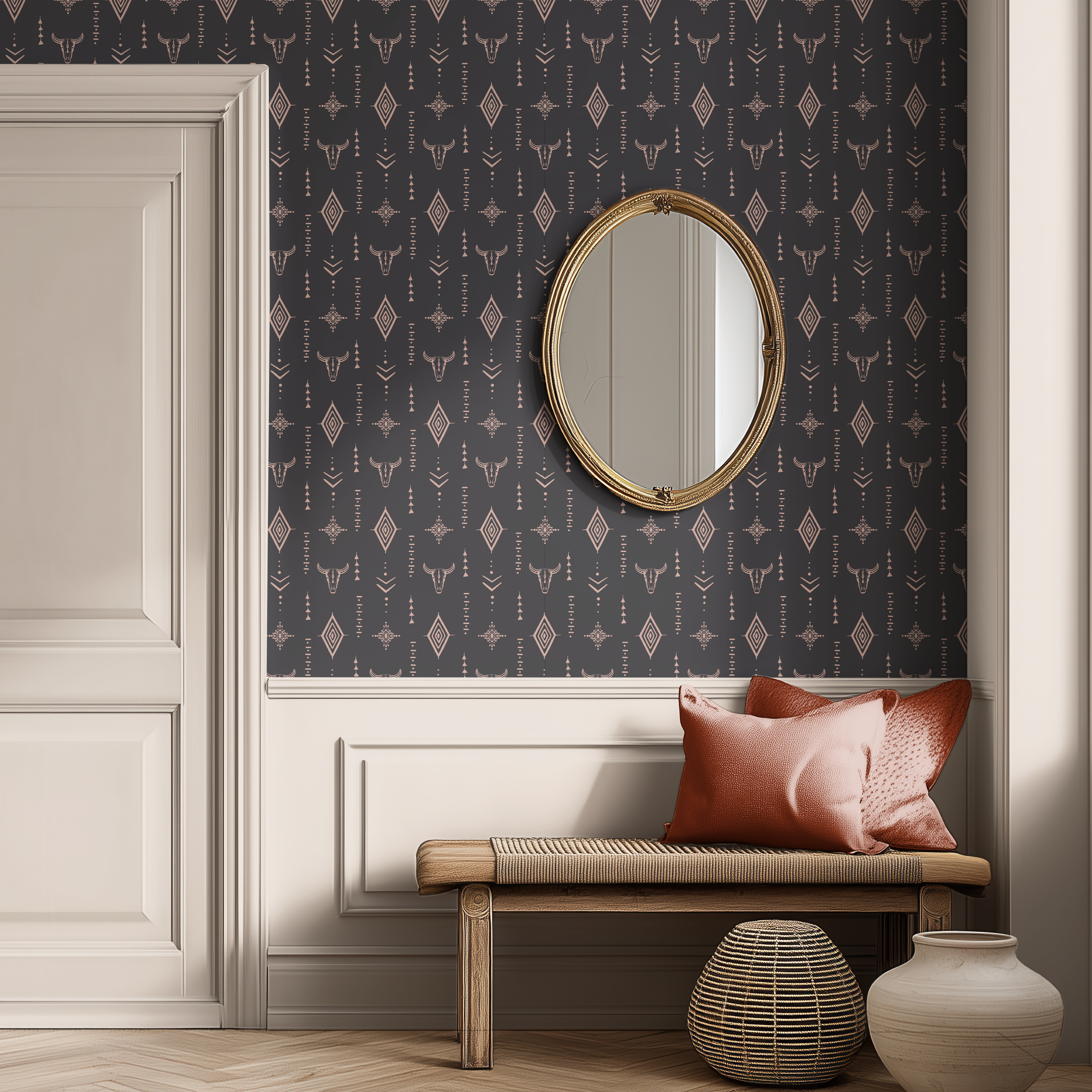 Dark western longhorn skull wallpaper in a modern entryway with white paneled walls, gold mirror and wooden bench.