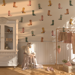 Western cowgirl boot wall decals in a girl’s bedroom with soft sunlight and kids’ decor.