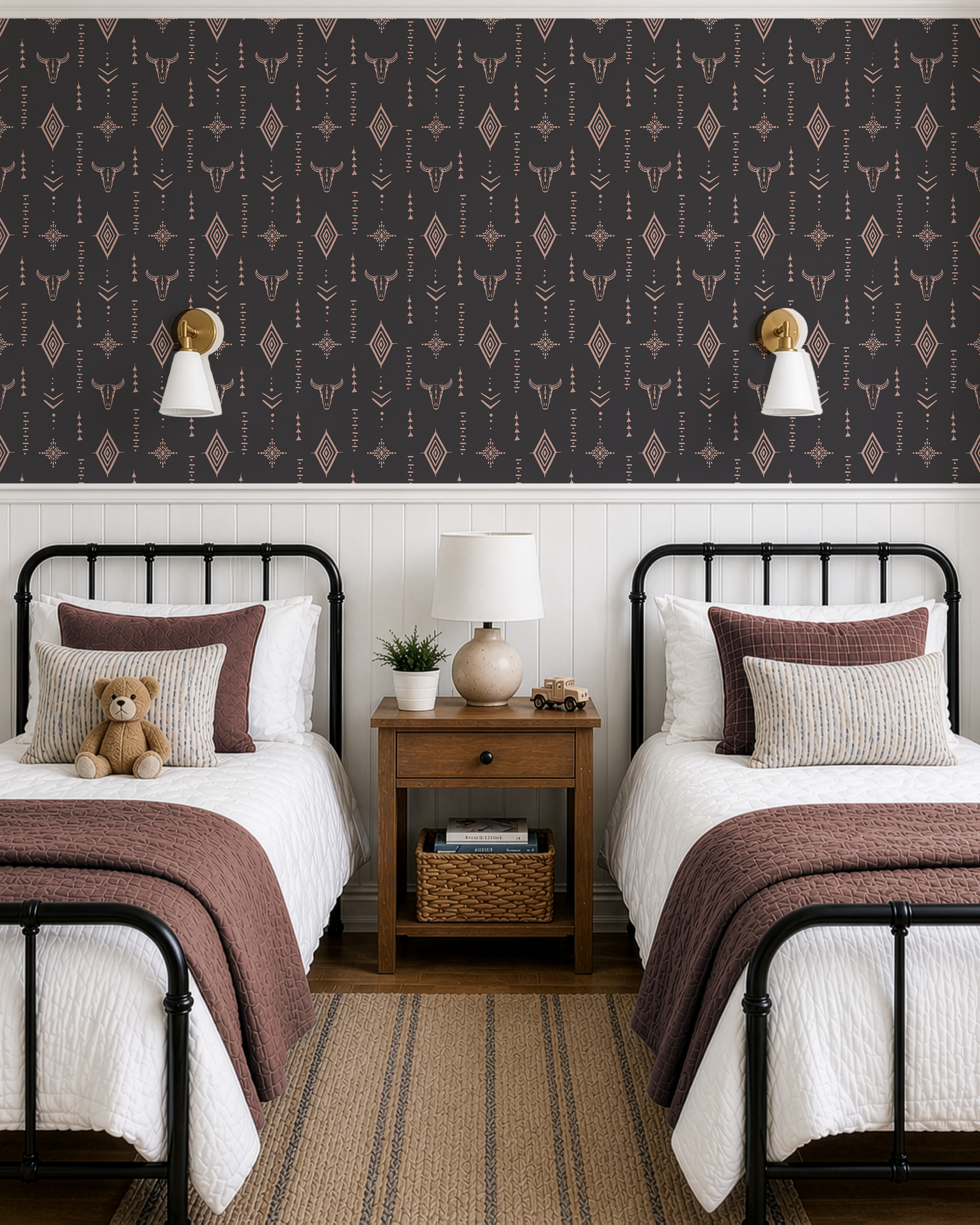 Rustic boys bedroom featuring western longhorn skull wallpaper, black metal twin beds, white wainscoting and wood nightstand.