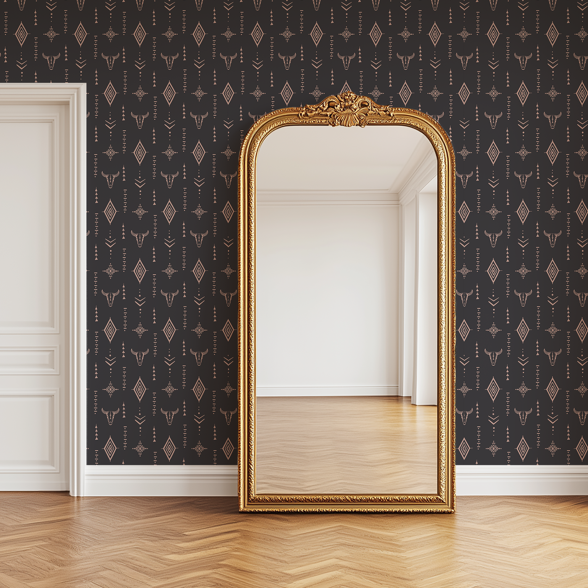 Western inspired charcoal wallpaper with longhorn skull pattern behind an antique gold floor mirror in a country style home.