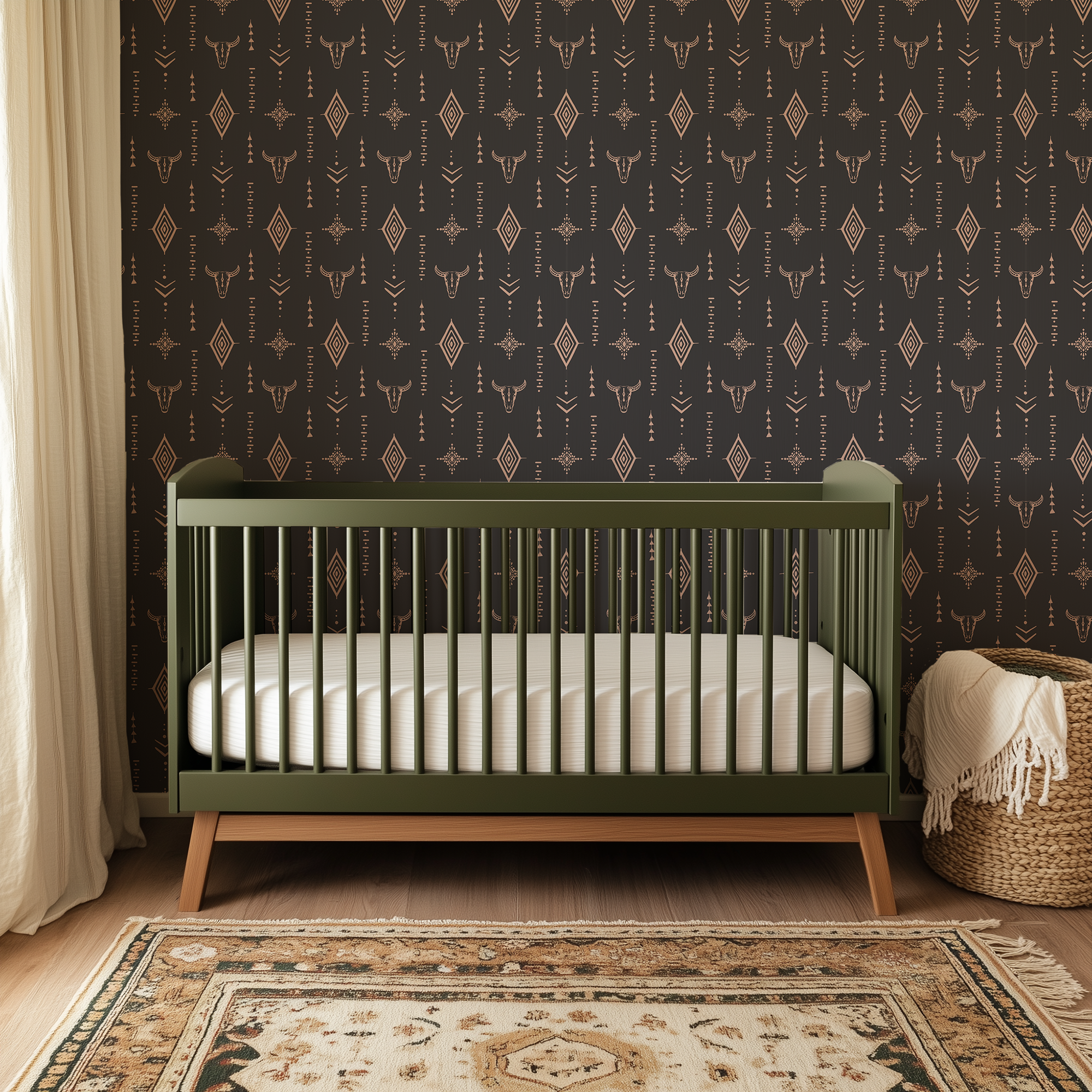 Western boho nursery with dark longhorn skull wallpaper, olive green crib, vintage rug and warm neutral decor.