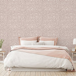 Bedroom with floral wallpaper, pink bed frame, and white bedding.