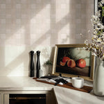 Zellige tile wallpaper used as a kitchen backsplash, styled with still life art, marble counter, and spring floral decor