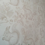 Close-up of a neutral nursery wallpaper depicting various woodland animals like rabbits and squirrels in a detailed beige sketch style.