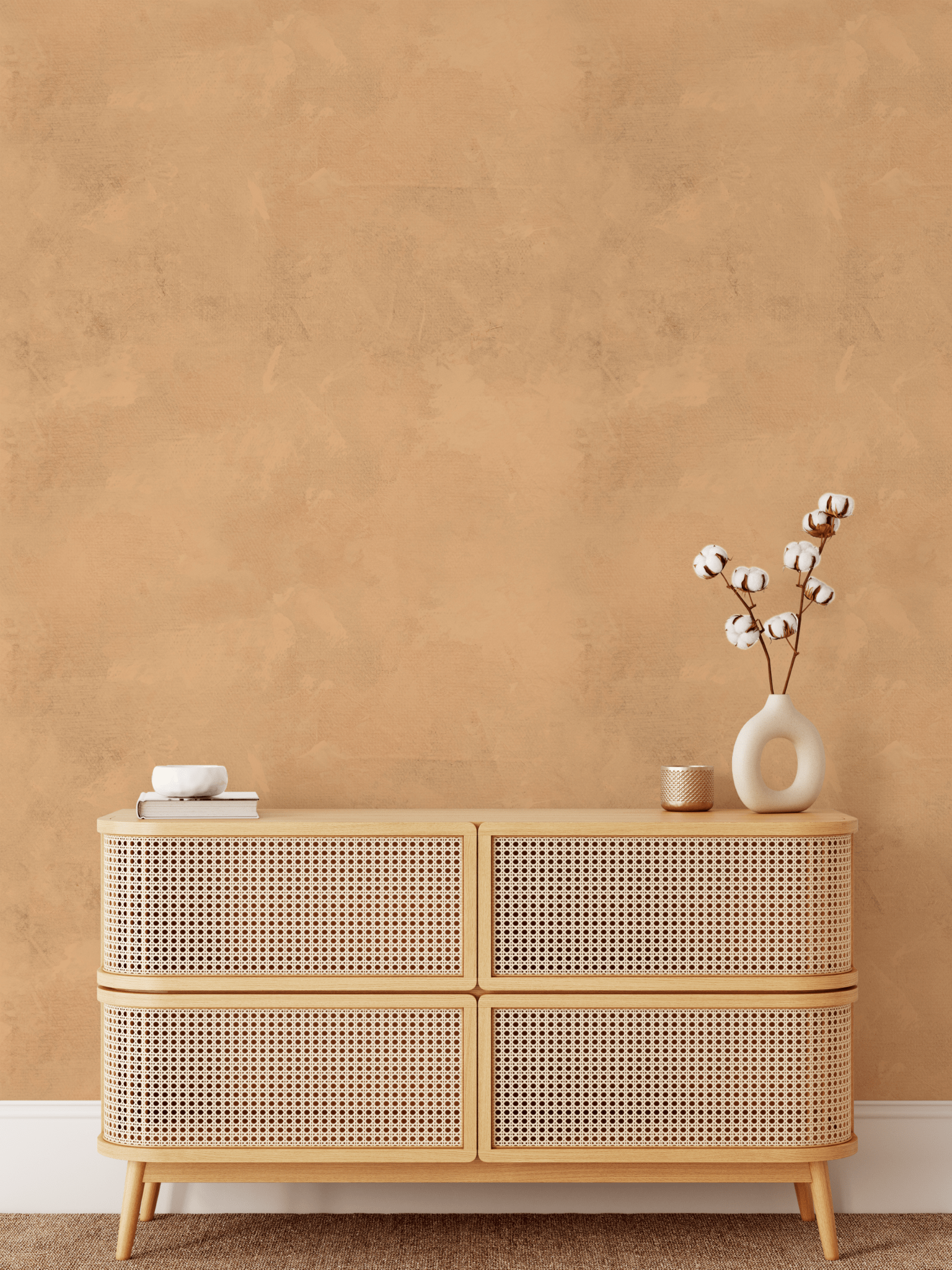 A boho-inspired room styled with Arizona limewash wallpaper, a light rattan dresser, white ceramic vase with cotton stems, and a cozy minimalistic aesthetic.